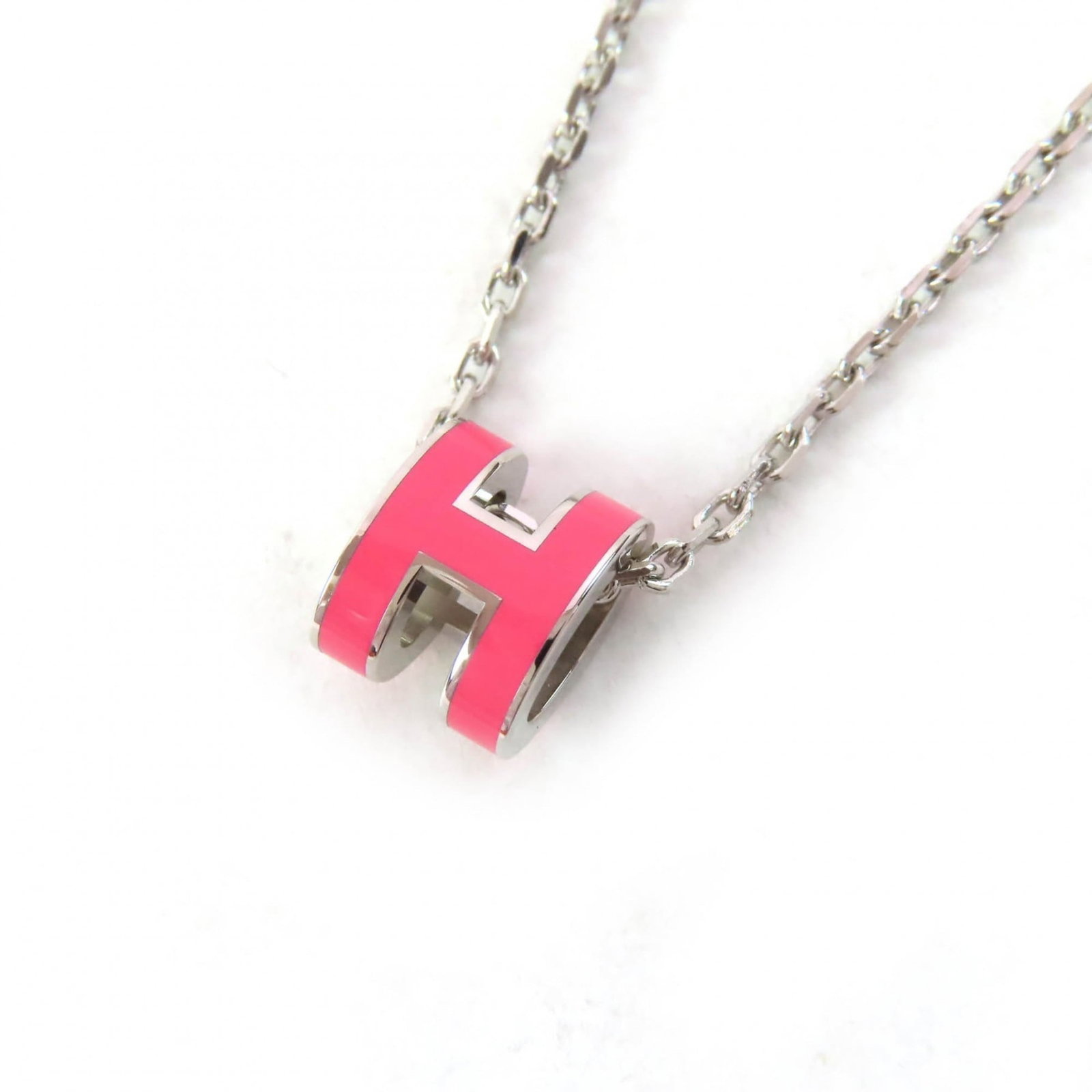 Hermes Mini Pop H Pendant Necklace In Pink And Silver Includes Box Dust Bag Made France Extremely: Hermes Mini Pop H Pendant Necklace In Pink And Silver Includes Box Dust Bag Made France Extremely Made in France, this Herm?s Mini Pop H Pendant Necklace features a striking pink and silver design.