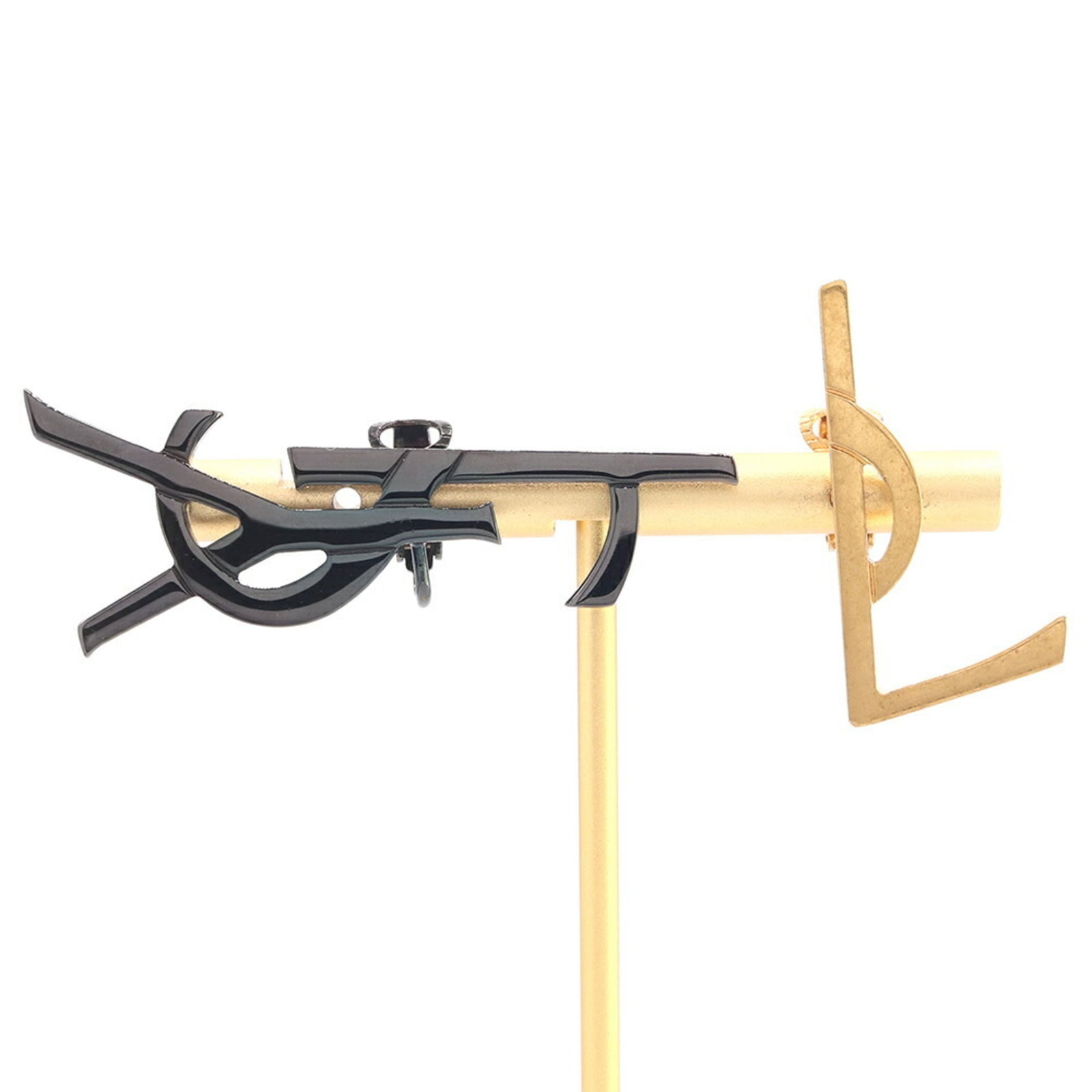 Saint Laurent Yves Clip Metal Earrings: Saint Laurent Yves Clip Metal Earrings Black and gold clip metal earrings from Yves Saint Laurent, featuring a sleek and modern design. Made from high-quality metal, these earrings are a stylish addit