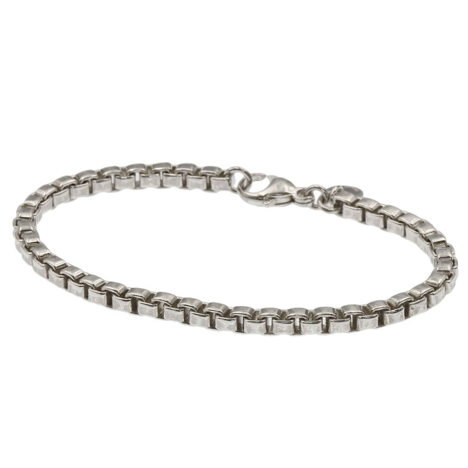 Silver Charm Bracelet by Tiffany: Silver Charm Bracelet by Tiffany Silver Charm Bracelet by Tiffany. This sterling silver charm bracelet boasts a sleek design, measuring 17cm in length. The intricate details and classic style make it