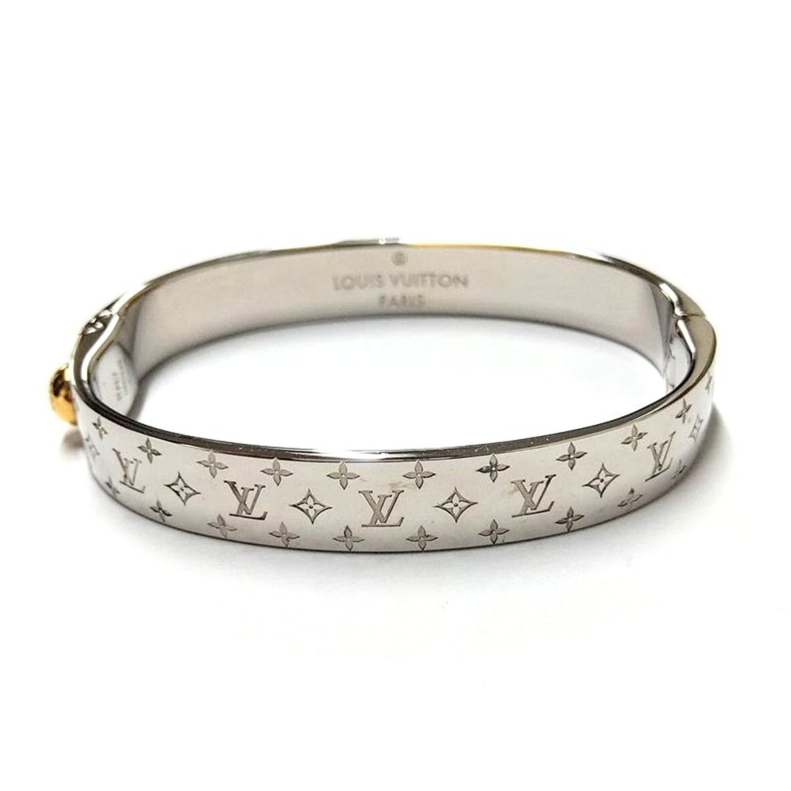 Vuitton Louis Cuff Bracelet: Vuitton Louis Cuff Bracelet Gold plated Louis Vuitton cuff bracelet with a silver finish, measuring 15cm in length and 9mm in width. This stylish accessory features the iconic Louis Vuitton design,