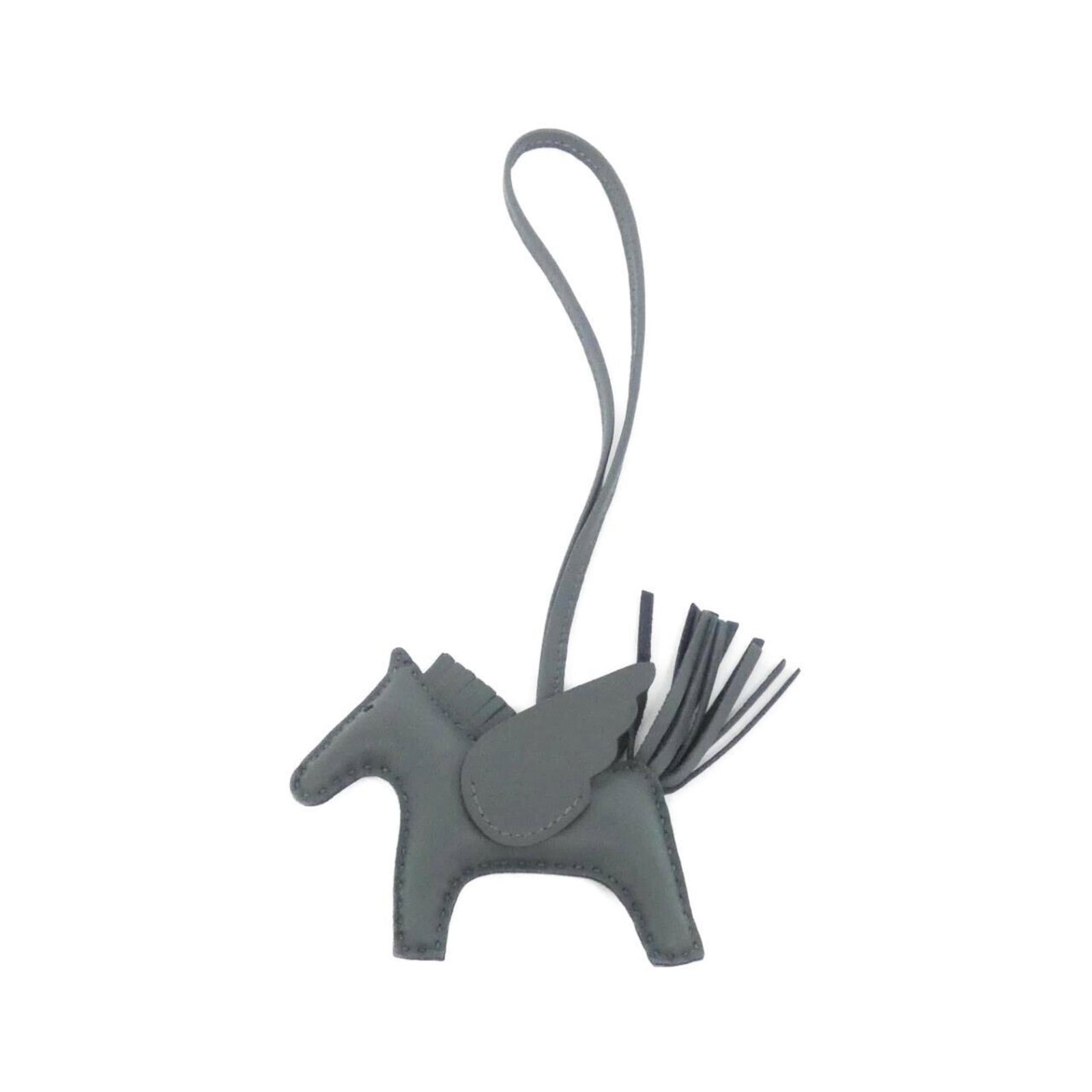 Hermes agneau handbag charm Milo: Hermes agneau handbag charm Milo Agneau Milo handbag charm from Hermes features a unique gray color and measures 75.00mm x 85.00mm in size, making it a distinctive accessory for handbags. This charm