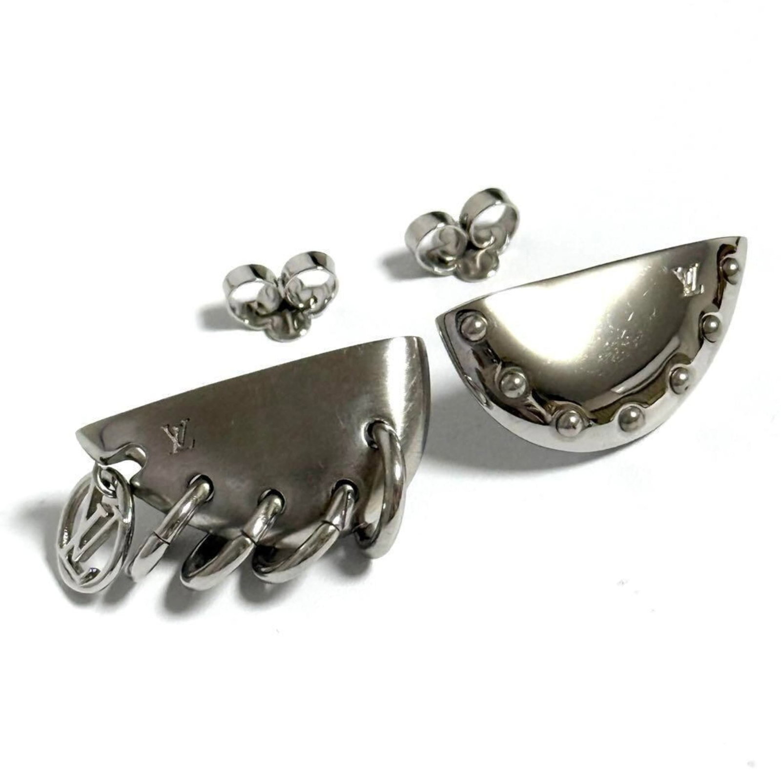 Metal Louis Vuitton Stud Earrings: Metal Louis Vuitton Stud Earrings Silver Metal Louis Vuitton Stud Earrings come with box and dust bag. The earrings are made from metal and feature the iconic Louis Vuitton design. They are a stylish 
