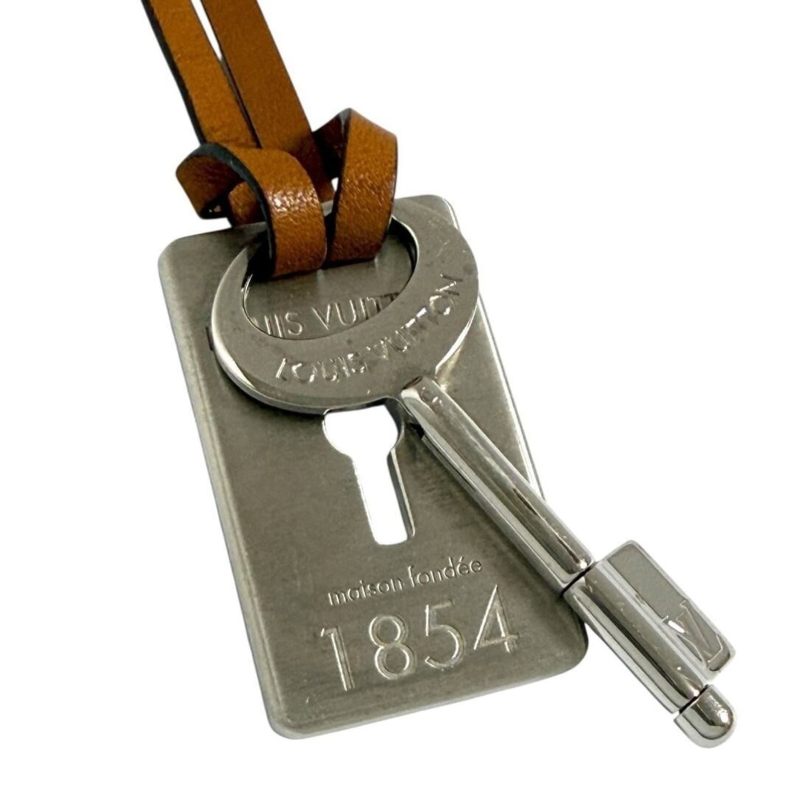 Men's travel key pendant necklace with leather cord from Louis Vuitton: Men's travel key pendant necklace with leather cord from Louis Vuitton Men's travel key pendant necklace with leather cord from Louis Vuitton features a metal pendant and a durable leather cord. The