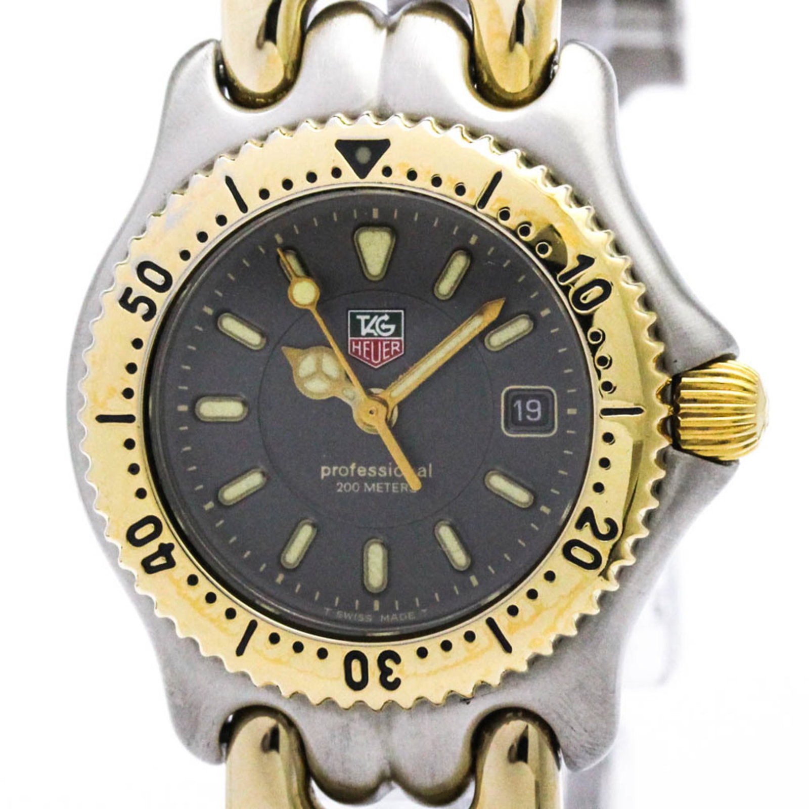 Wristwatch From Tag: Wristwatch From Tag Gold plated and stainless steel, this Tag Heuer Sel wristwatch boasts a sleek gray dial. With its quartz movement and date function, it's a stylish accessory for formal occasions.