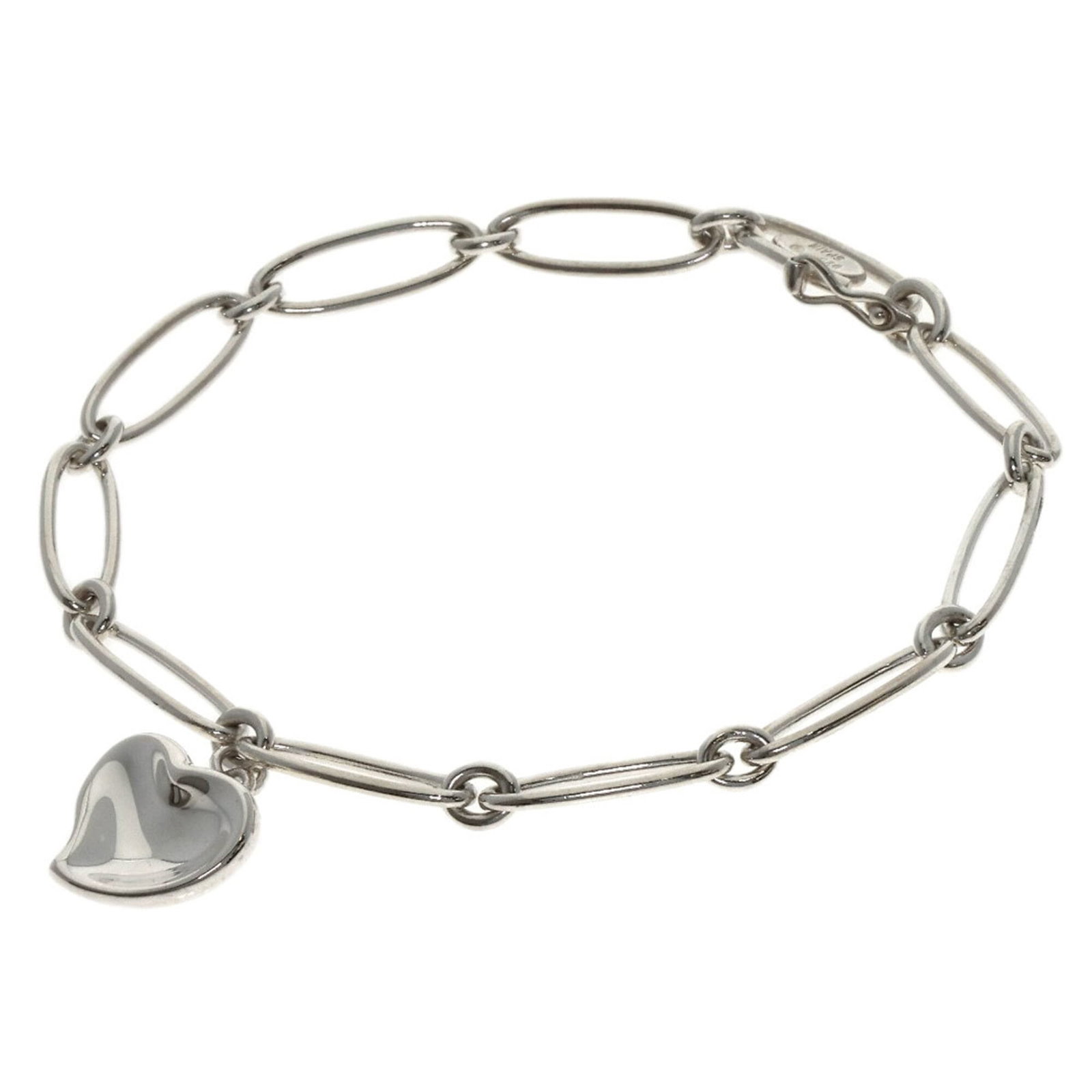 Silver Charm Bracelet by Tiffany: Silver Charm Bracelet by Tiffany Silver Charm Bracelet by Tiffany features a delicate full heart charm in sterling silver, suspended from a sleek chain. The bracelet measures 17.5cm in length, offerin