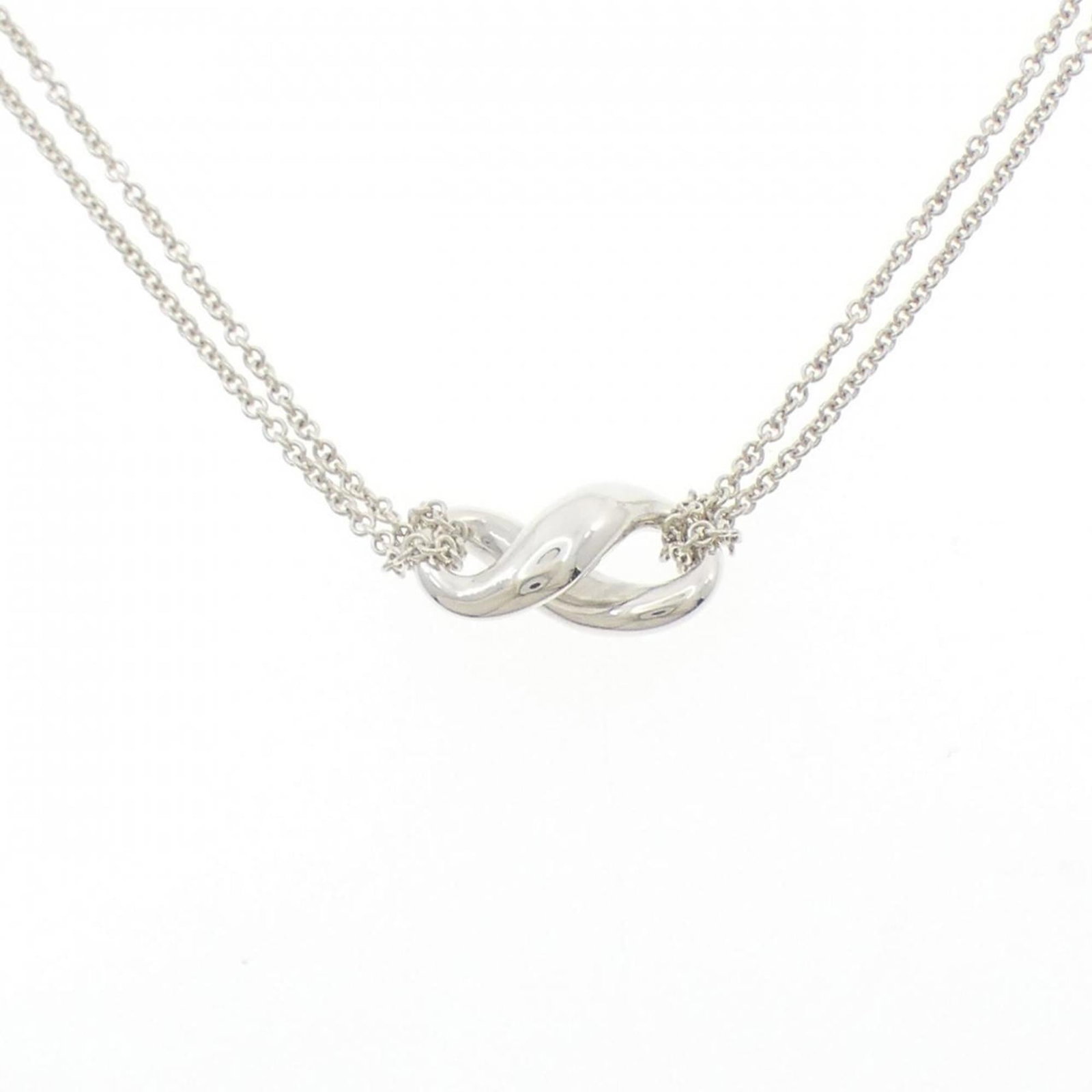 Figure Eight Necklace by Tiffany: Figure Eight Necklace by Tiffany Silver 925 Figure Eight Necklace with a sleek design, perfect for adding a touch of elegance to any outfit. The necklace features a simple yet striking figure eight