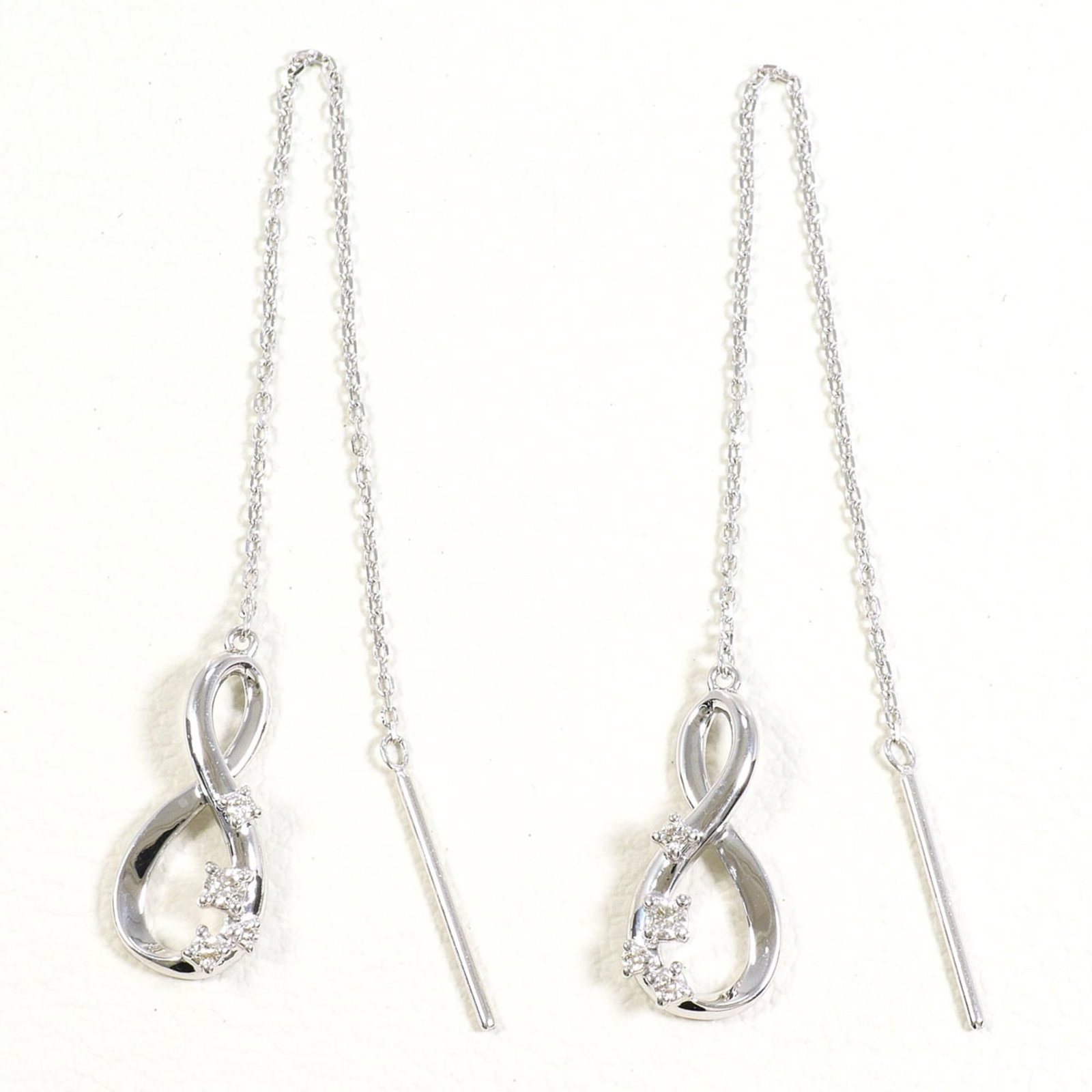White Gold Chain Earrings Unbranded: White Gold Chain Earrings Unbranded White gold chain earrings feature a high-karat metal composition and a diamond weight, making them a striking accessory. The 18K white gold material provides