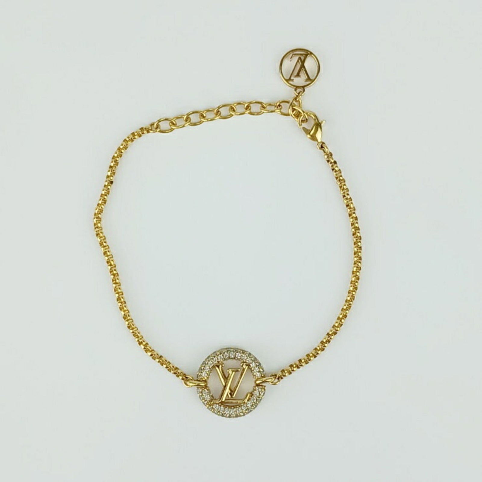 Louis Vuitton Charm Bracelet Rhinestone: Louis Vuitton Charm Bracelet Rhinestone Rhinestones catch the light in gold, adding a touch of luxury to this Louis Vuitton charm bracelet. Made from high-quality rhinestone material, it's a