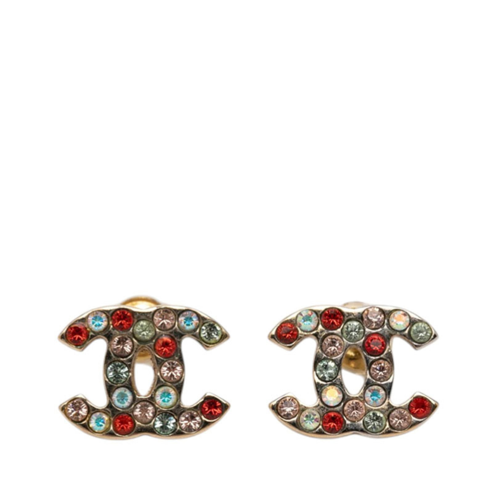 Rhinestone stud earrings Chanel: Rhinestone stud earrings Chanel Rhinestone stud earrings from Chanel feature multi-color stones, measuring 12.70mm x 9.90mm in size. The rhinestones are set on a sturdy backing, adding to the overall 