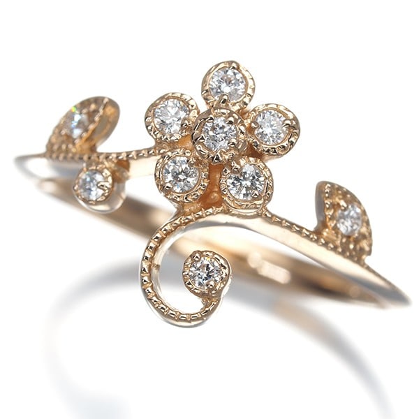 Milgrain 0.12ct flower ring diamond 18k rose gold: Milgrain 0.12ct flower ring diamond 18k rose gold Rose gold 18k metal craftsmanship shines in this delicate flower ring, adorned with a natural diamond weighing 0.12ct. The ring's slender design and