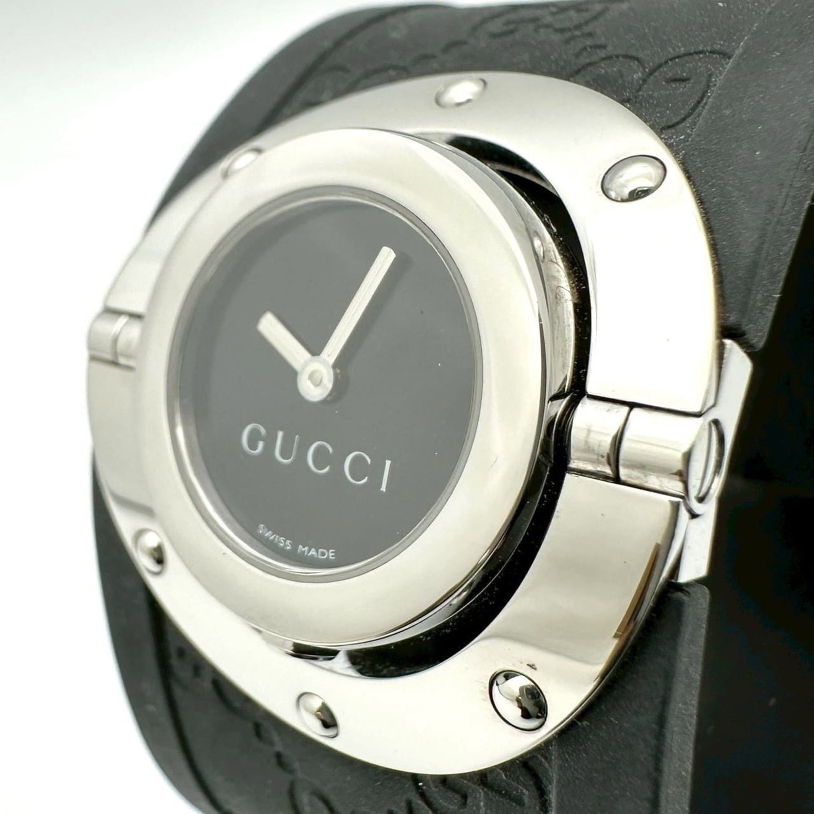 Gucci Wristwatch: Gucci Wristwatch Stainless steel case and rubber band provide a sleek, durable design for the Gucci wristwatch. The black quartz movement keeps time with precision, while the 23mm case diameter fits c