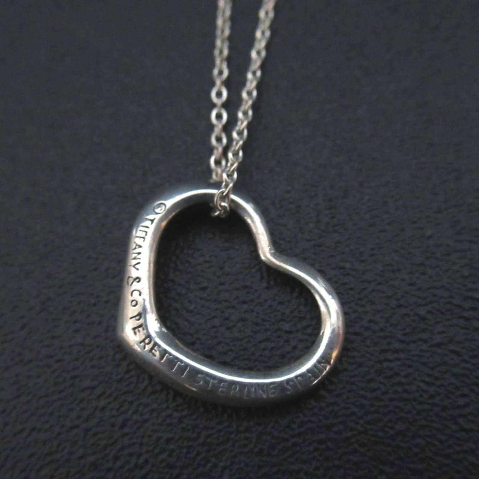 Vintage Elsa Peretti Open Heart Necklace Pendant in Sterling Silver by Tiffany and Co Women: Vintage Elsa Peretti Open Heart Necklace Pendant in Sterling Silver by Tiffany and Co Women Sterling silver pendant necklace from Tiffany and Co, featuring an open heart design. This elegant piece