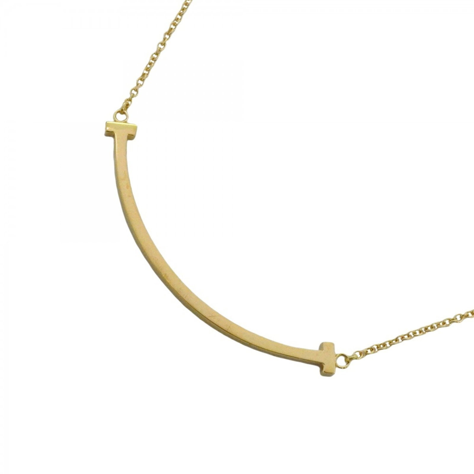 Tiffany Co T Smile Necklace Small Women's 18K Yellow Gold: Tiffany Co T Smile Necklace Small Women's 18K Yellow Gold Tiffany Co's T Smile Necklace is a stunning piece of 18K yellow gold jewelry, featuring a small pendant with dimensions of 9.8mm x 37.6mm.