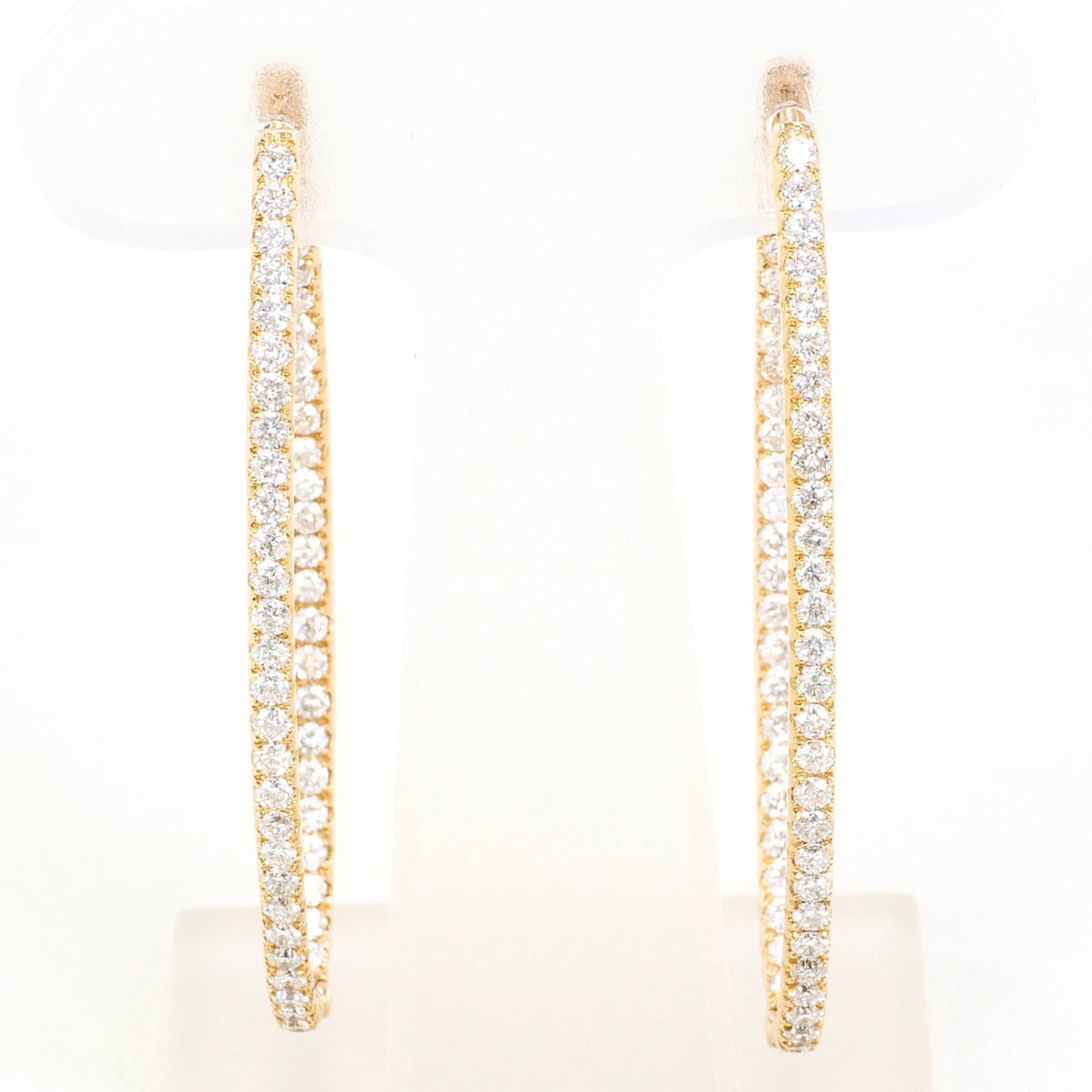 Pink Gold Hoop Earrings 18K: Pink Gold Hoop Earrings 18K Pink gold hoop earrings feature a beautiful 18K metal construction, showcasing a delicate pink hue. Each earring weighs approximately 0.25oz and contains a 1.91ct diamond