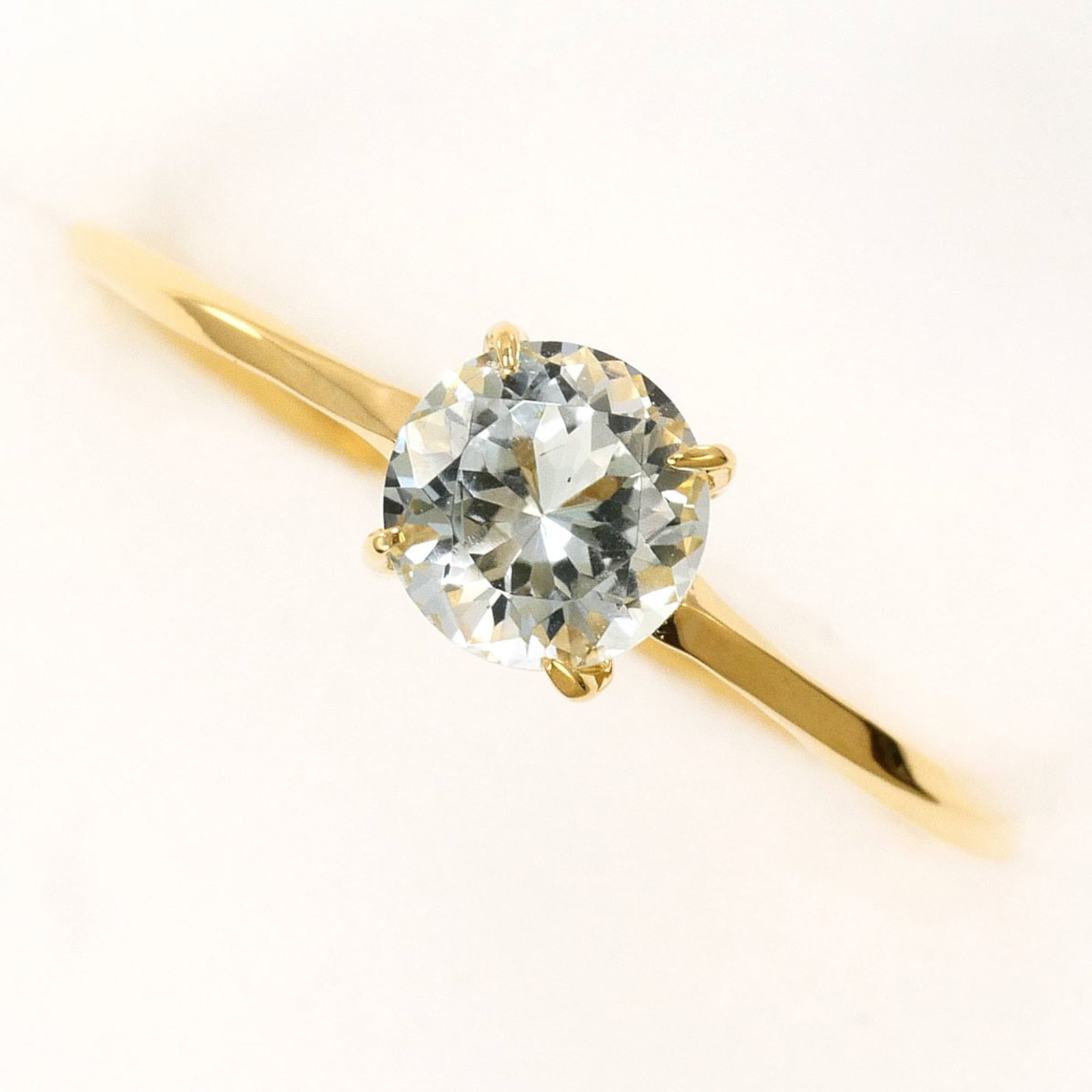 Unbranded Band Ring Yellow Gold (18K): Unbranded Band Ring Yellow Gold (18K) Yellow gold band ring with a topaz stone, available in US size 6 and JP size 11. This 18K yellow gold piece features a width of 5mm and weighs approximately