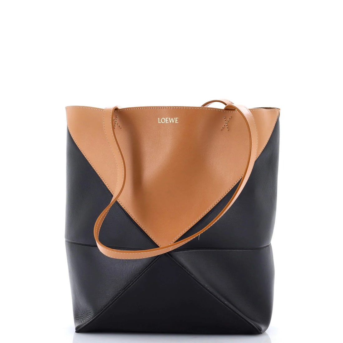 Loewe Puzzle Fold Tote Leather Medium: Loewe Puzzle Fold Tote Leather Medium The Loewe Puzzle Fold Tote Leather Medium boasts a rich, brown leather exterior with subtle scuffs and edge wear, giving it a well-loved, vintage charm. This