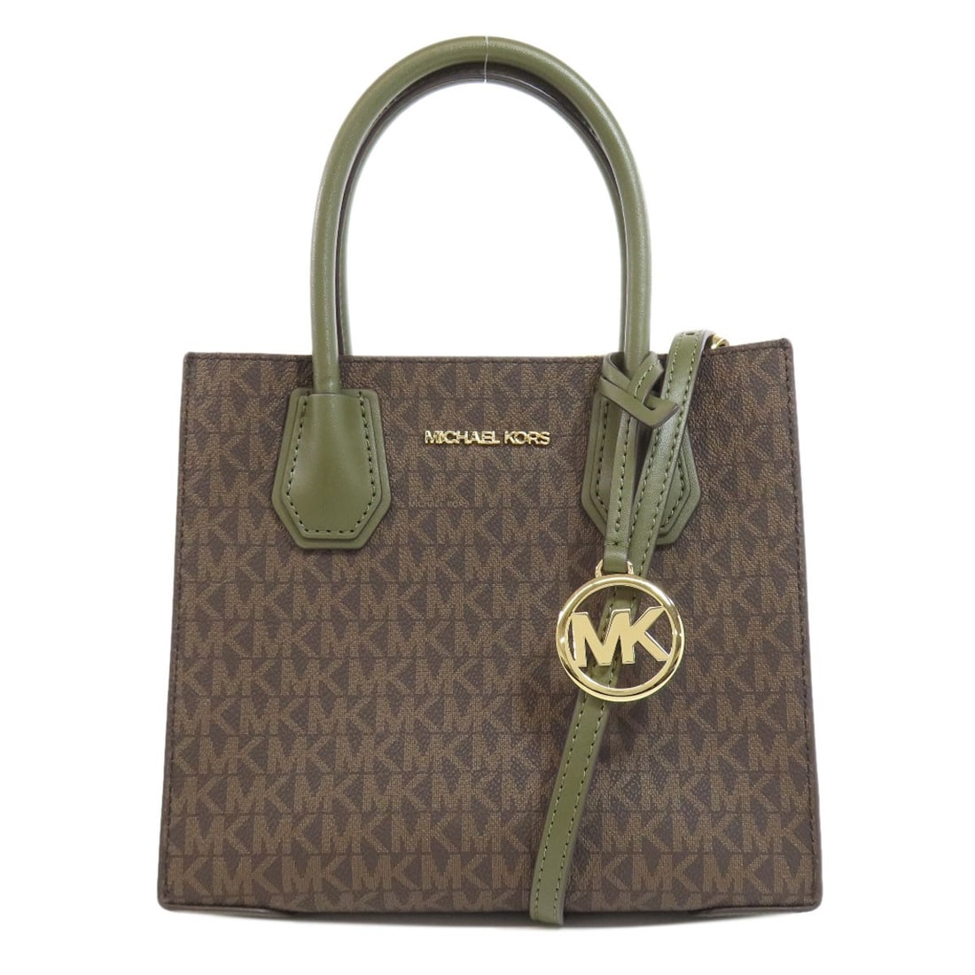 Michael Kors Mk Signature Handbag Pvc: Michael Kors Mk Signature Handbag Pvc This Michael Kors Mk Signature Handbag features a striking brown exterior made from PVC, a durable and modern material. The handbag's design showcases its