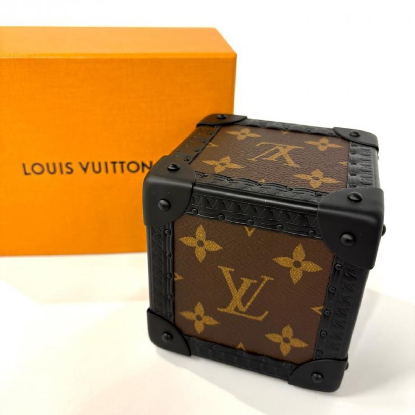 Louis Vuitton: Louis Vuitton Brown Louis Vuitton figurine with dimensions 90.00mm x 90.00mm x 90.00mm, standing 3.54'' x 3.54'' x 3.54''. The item bears a signature and is made from an unspecified material. Item