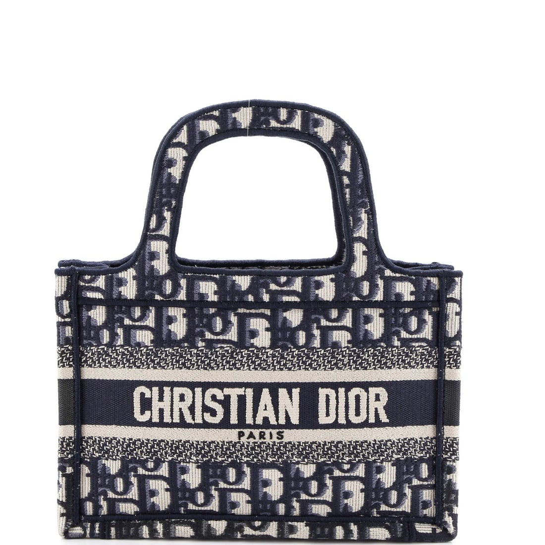 Dior Christian Oblique Book Mini Canvas Tote: Dior Christian Oblique Book Mini Canvas Tote The Dior Christian Oblique Book Mini Canvas Tote boasts a sleek blue exterior and interior, crafted from high-quality canvas. With its compact size and