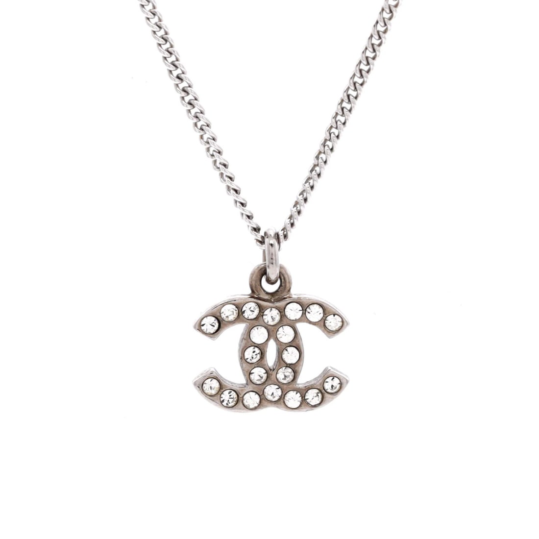 Crystal CC Logo Necklace Metal by Chanel: Crystal CC Logo Necklace Metal by Chanel The CC Crystal Logo Necklace Metal by Chanel boasts an elegant silver metal exterior, featuring a subtle crystal logo. With its understated yet sophisticated d