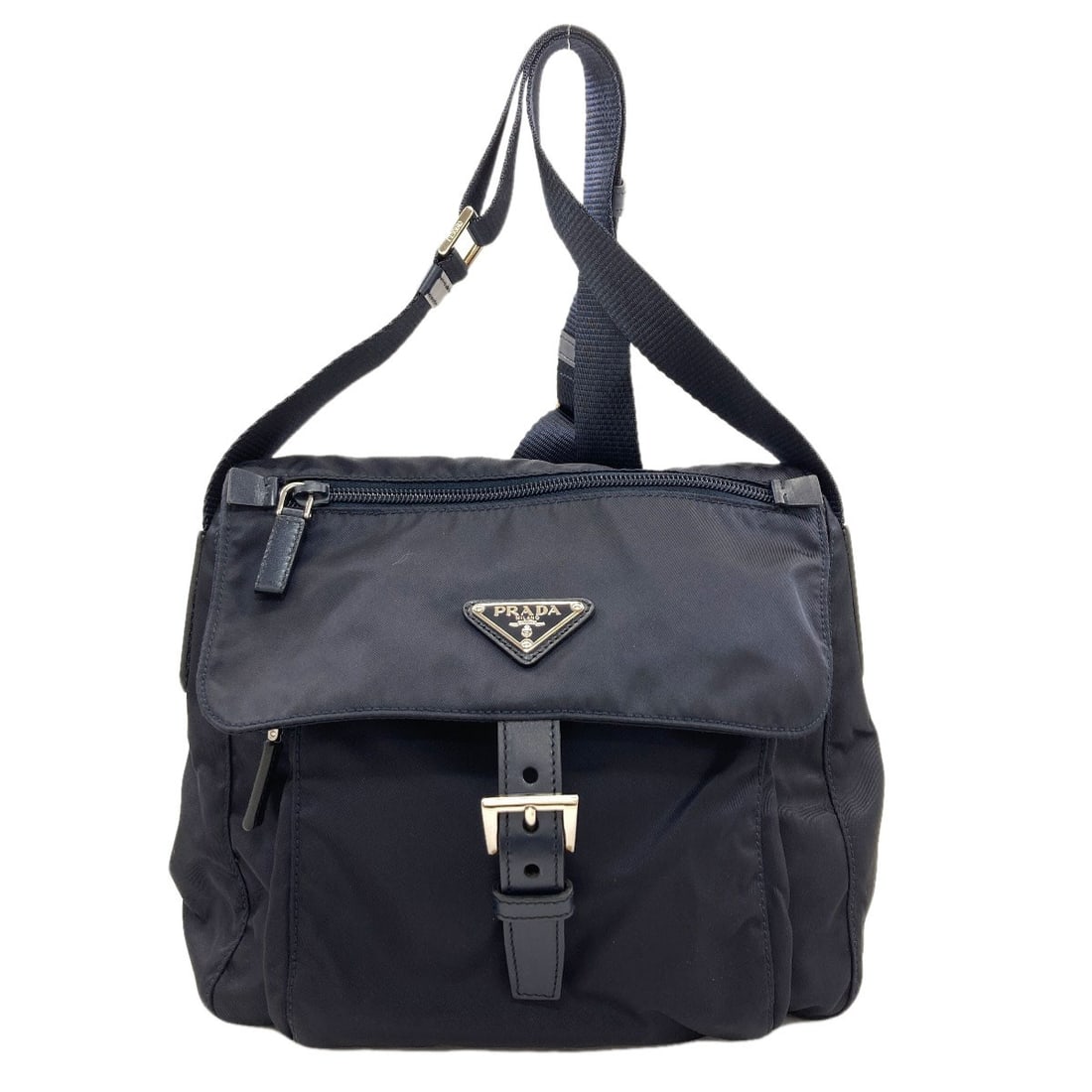 Nylon shoulder bag hardware logo by Prada: Nylon shoulder bag hardware logo by Prada Nylon shoulder bag hardware logo by Prada, featuring black exterior with nylon material. The distinctive logo stands out as a notable design element on the ba