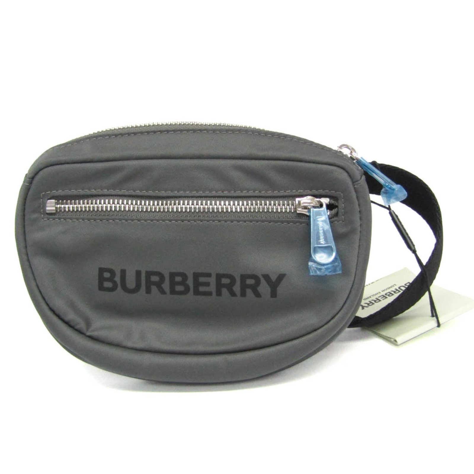 Nylon bag fanny pack sling from Burberry: Nylon bag fanny pack sling from Burberry The Burberry nylon fanny pack sling features a sleek gray color and a practical zipper closure, with an outer pocket for added storage. Its durable nylon