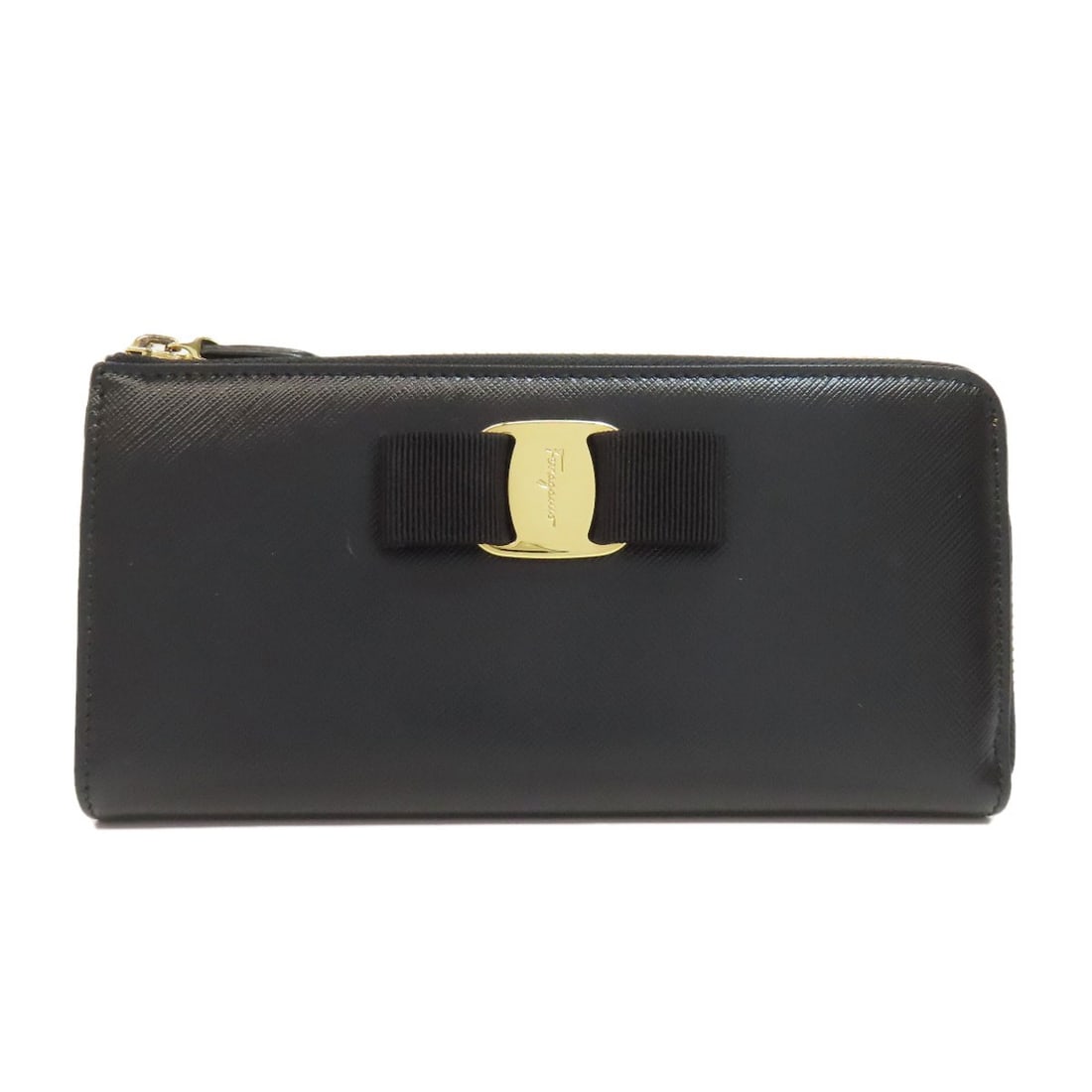 Salvatore Ferragamo Vara Ribbon Long Wallet (With Coin Pocket) Leather: Salvatore Ferragamo Vara Ribbon Long Wallet (With Coin Pocket) Leather Black leather long wallet with coin pocket, bearing the signature of Salvatore Ferragamo. This classic design features a sleek