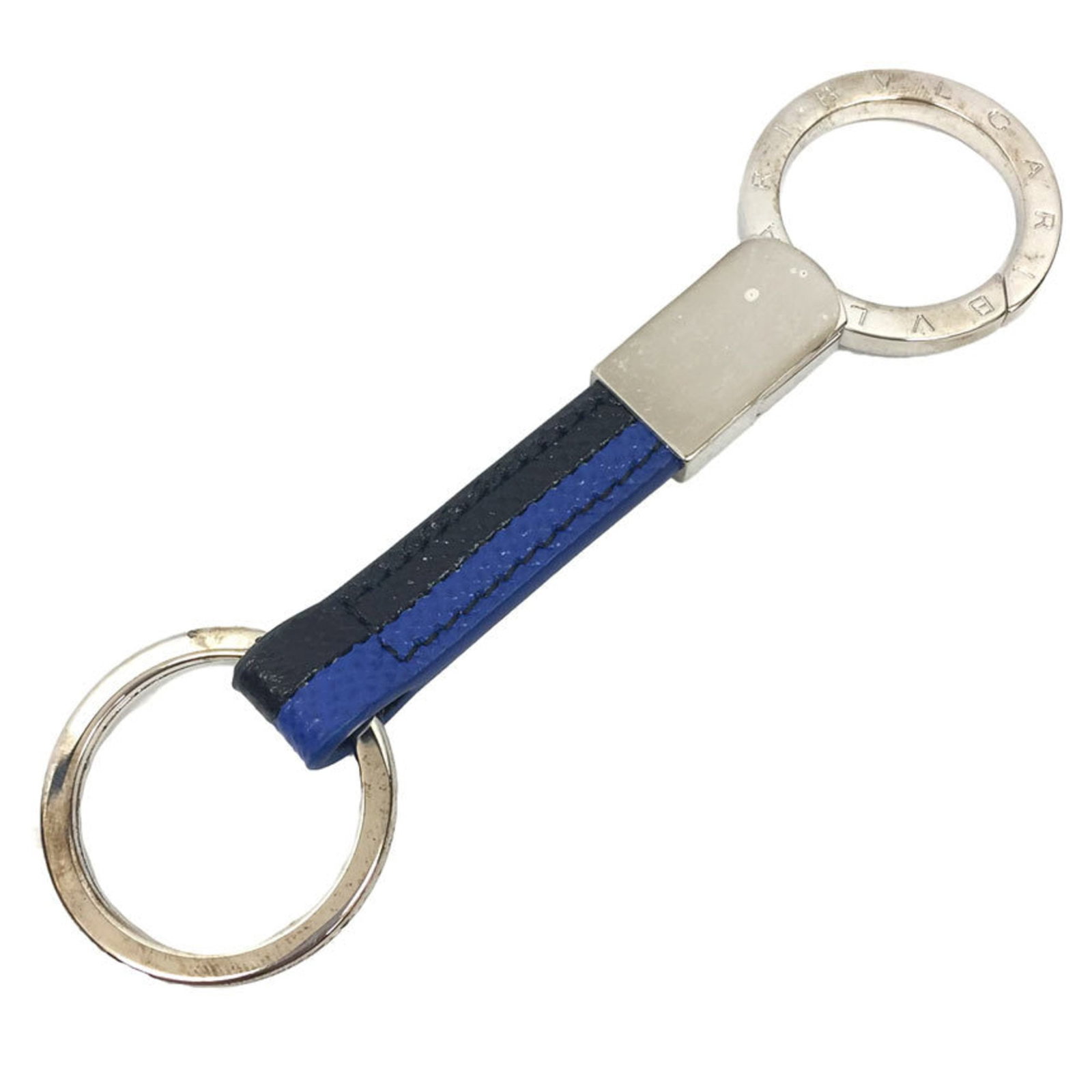 Keyring Brass Leather by Bvlgari: Keyring Brass Leather by Bvlgari Brass and leather come together in sleek design, defining the Bvlgari Keyring. Made from brass and adorned with high-quality leather, this keyring showcases a classic 