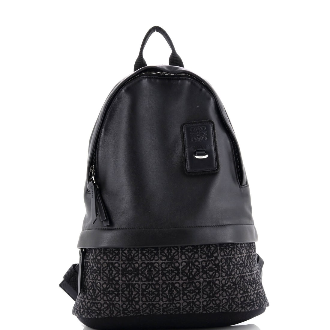 Slim Round Leather Backpack Jacquard Anagram Loewe: Slim Round Leather Backpack Jacquard Anagram Loewe Black leather backpack with a unique Jacquard anagram design, featuring silver hardware and minor scuffs on the exterior. The interior is also adorne