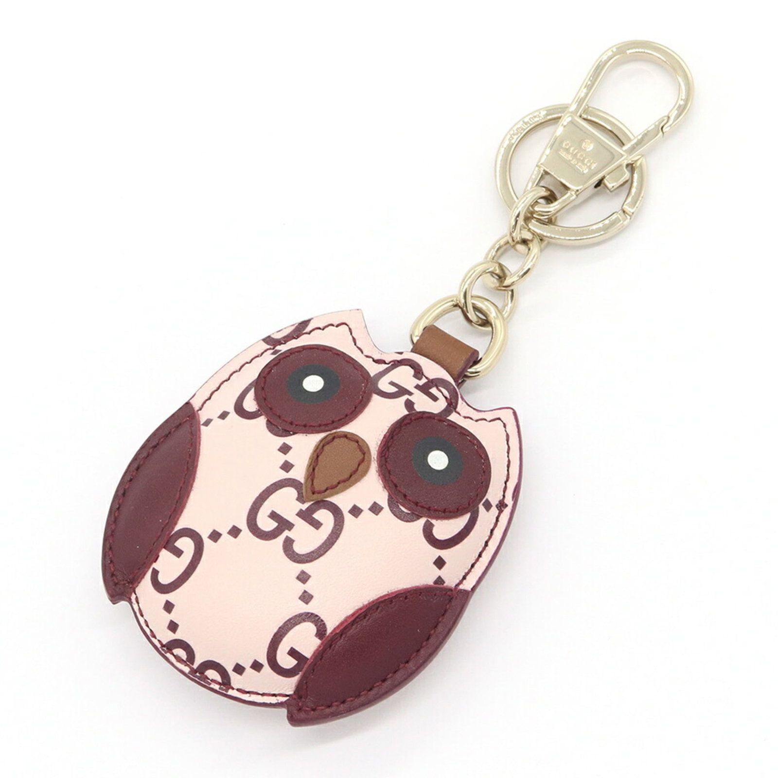 Keyring Leather Gucci: Keyring Leather Gucci This Gucci leather keyring boasts a classic Bordeaux and light pink color combination, adding a touch of elegance to any accessory. Made from high-quality leather, its sleek desi