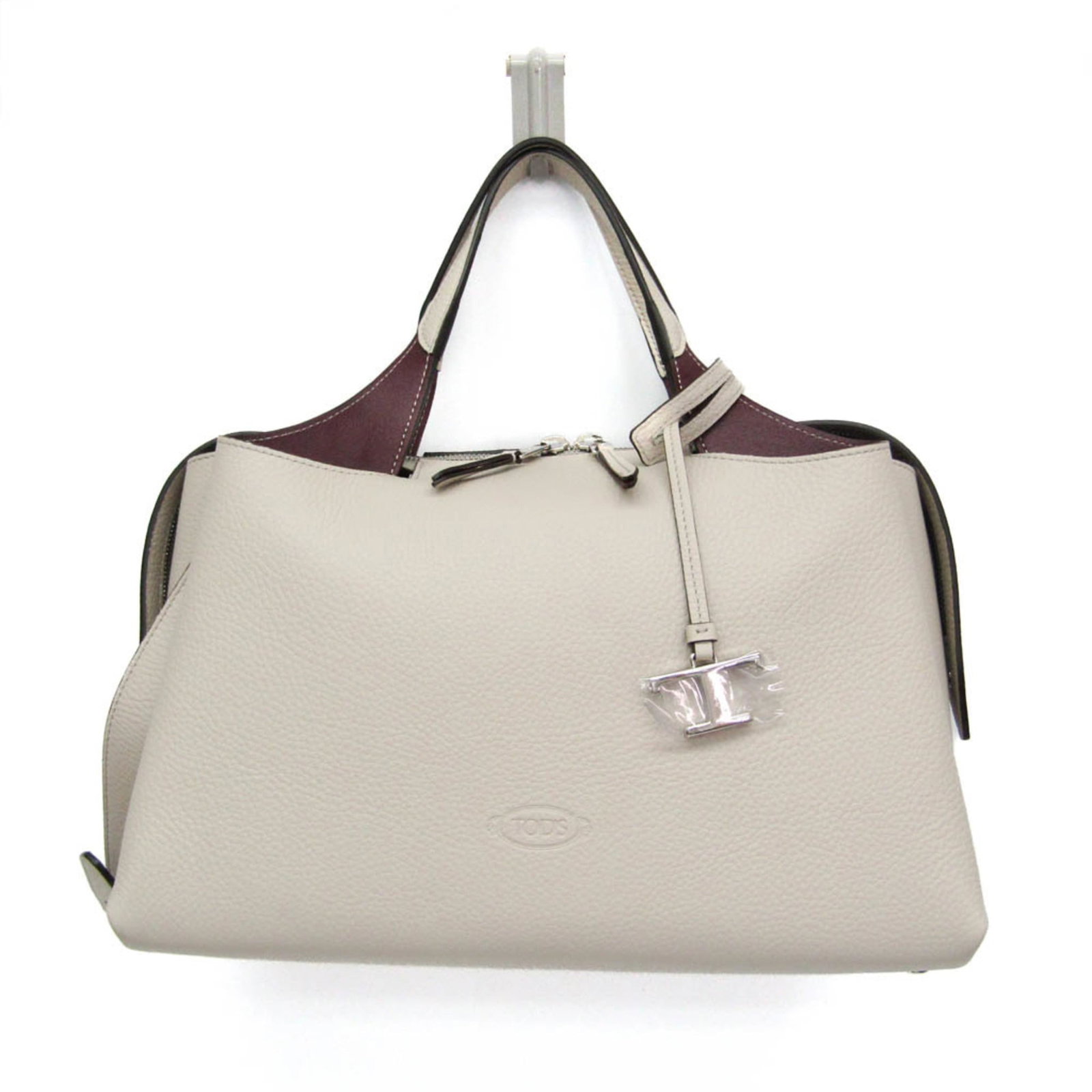 Handbag Leather Shoulder Bag Tod's: Handbag Leather Shoulder Bag Tod's The Tod's Bauletto Bag Medium XBWAPAHL300QRI5O90 features a stunning light gray and wine leather exterior, adorned with a zipper closure. This spacious shoulder bag
