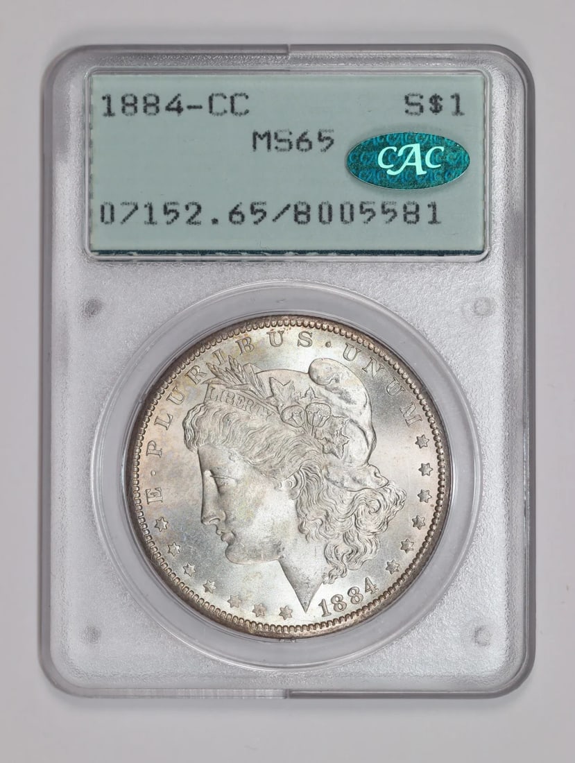 CC MORGAN DOLLAR MS65 OGH RATTLER PCGS 1884: CC MORGAN DOLLAR MS65 OGH RATTLER PCGS 1884 PCGS and CAC certified MS65 OGH, the CC Morgan Dollar 1884 features a striking silver composition and exceptional mint state condition. This highly detailed