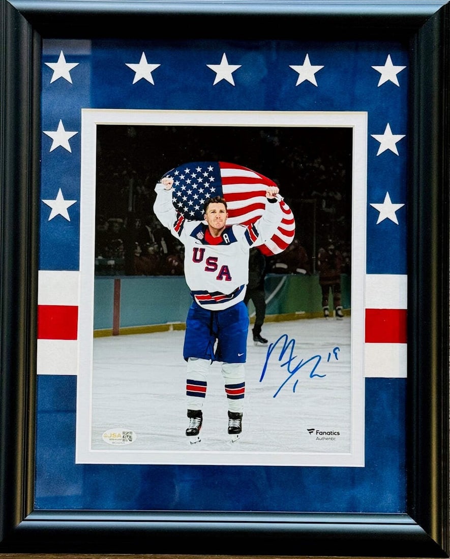 Tkachuk Autographed 8x10 Olympics Team USA JSA Witness: Tkachuk Autographed 8x10 Olympics Team USA JSA Witness Matthew Tkachuk's sharpie signature across the front of this 8x10 photo of Team USA at the Olympics adds a unique touch to this official James Sp