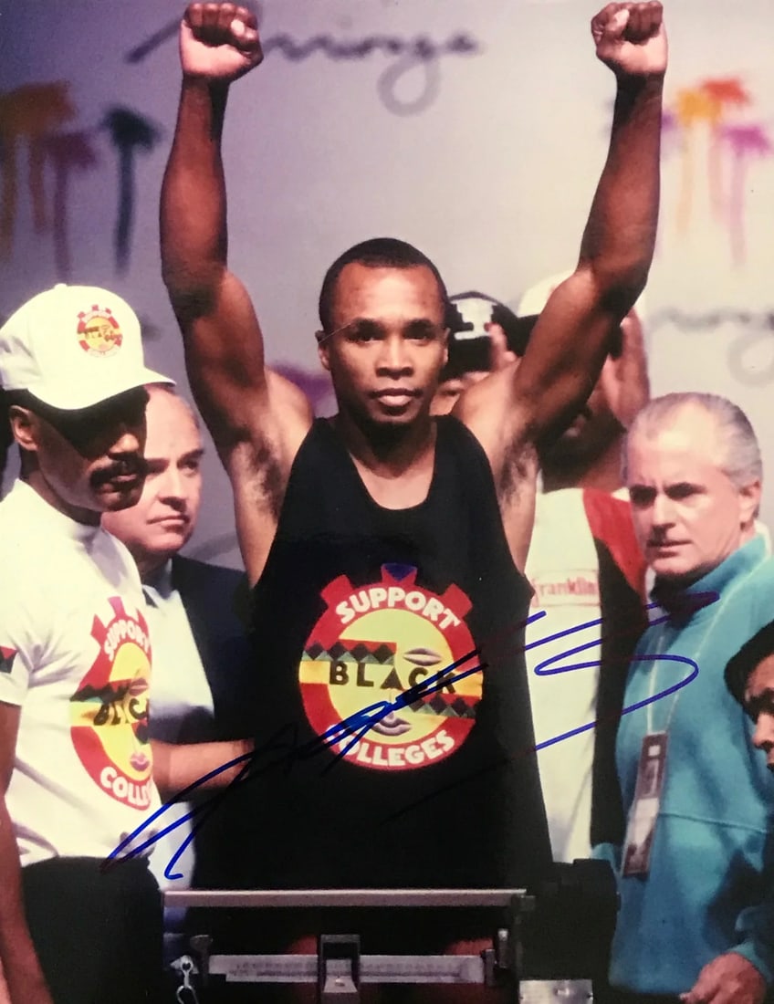 Sugar Ray Leonard Autographed 8x10 Boxing Photo: Sugar Ray Leonard Autographed 8x10 Boxing Photo Sugar Ray Leonard's iconic boxing career is captured in this 8x10 photo, signed across the front in blue sharpie. The legendary boxer's signature adds a