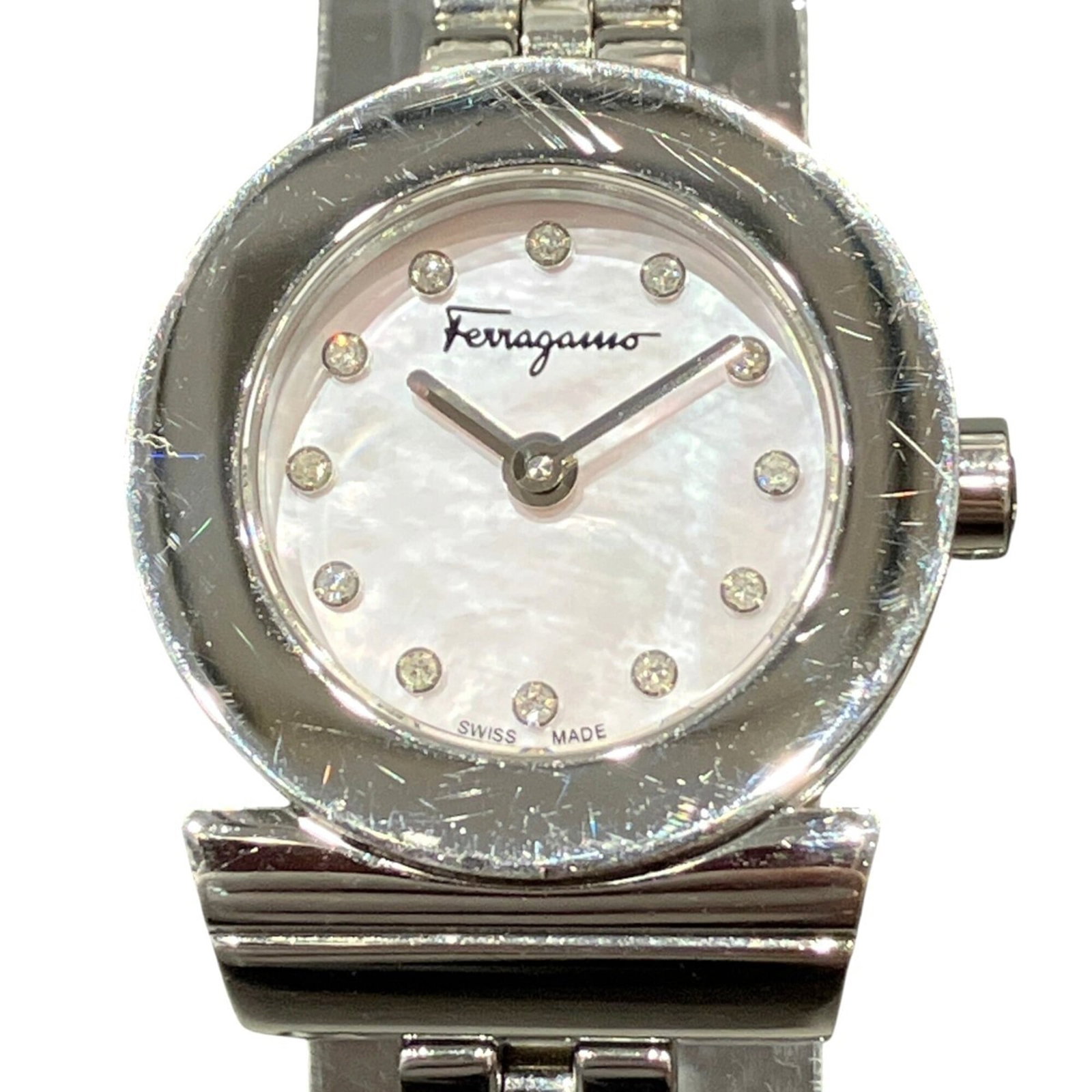 Salvatore Ferragamo Wristwatch: Salvatore Ferragamo Wristwatch Stainless steel case and band make up the sleek silhouette of this Salvatore Ferragamo wristwatch, with a striking pink dial that adds a touch of elegance. Measuring 22m