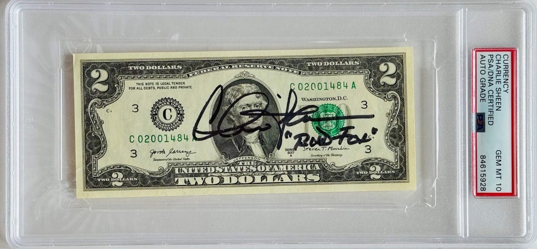 Sheen Autographed Bill Dollar Slabbed PSA Gem Mt 10: Sheen Autographed Bill Dollar Slabbed PSA Gem Mt 10 Charlie Sheen's sharpie signature on a PSA Gem Mt 10 slabbed 2 dollar bill, featuring the inscription "Bud Fox". This unique piece showcases the act