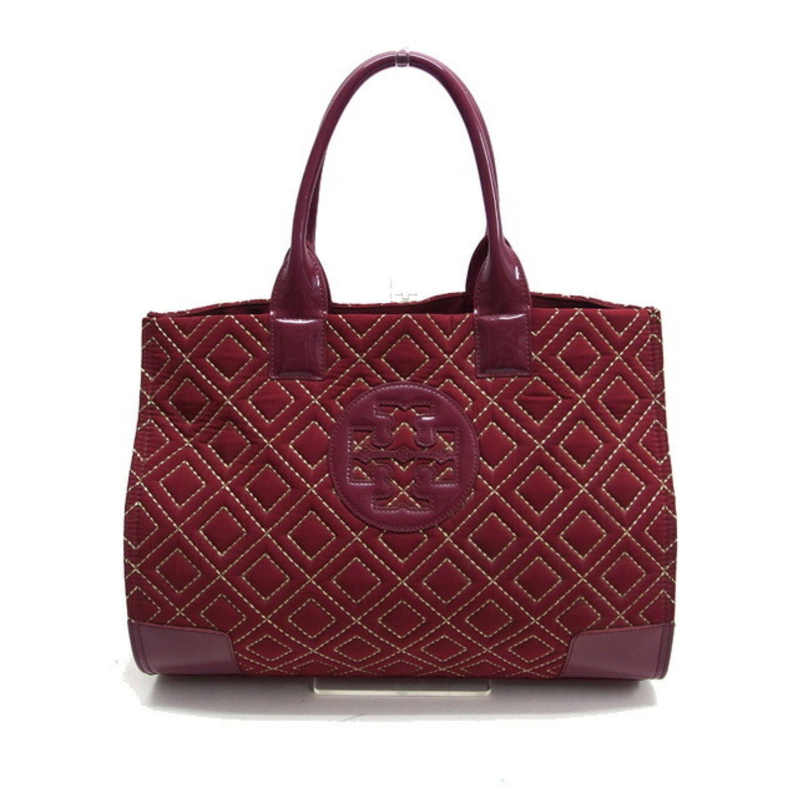 Tory Burch tote bag nylon patent leather shoulder bag: Tory Burch tote bag nylon patent leather shoulder bag Tory Burch's nylon patent leather shoulder bag boasts a sleek Bordeaux color and striking red accents, adding a pop of sophistication to any outfi