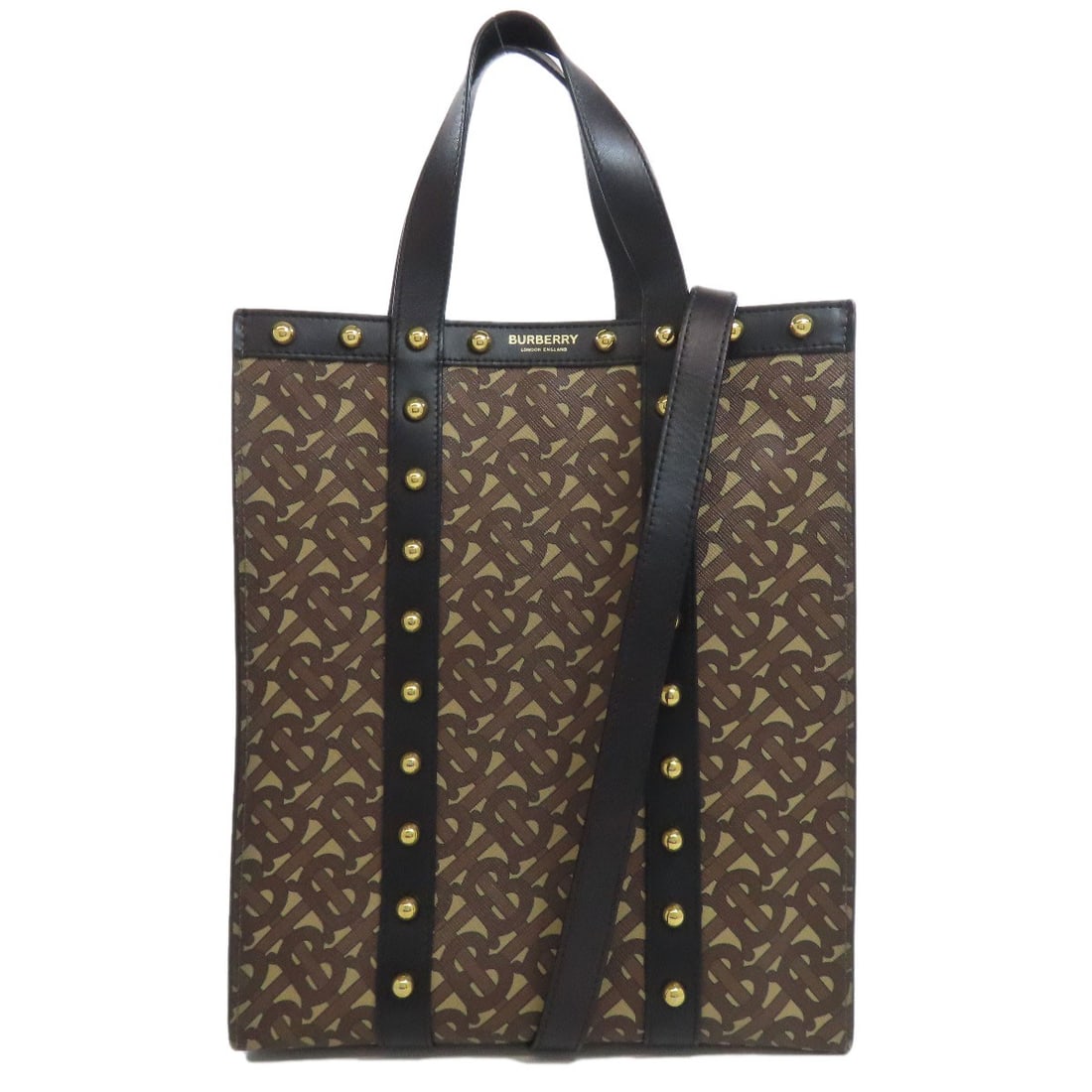 PVC leather 2way tote bag with Burberry logo: PVC leather 2way tote bag with Burberry logo Brown PVC leather tote bag with the Burberry logo, made from PVC. The tote features a classic design and a prominent brand logo on its exterior. This bag i