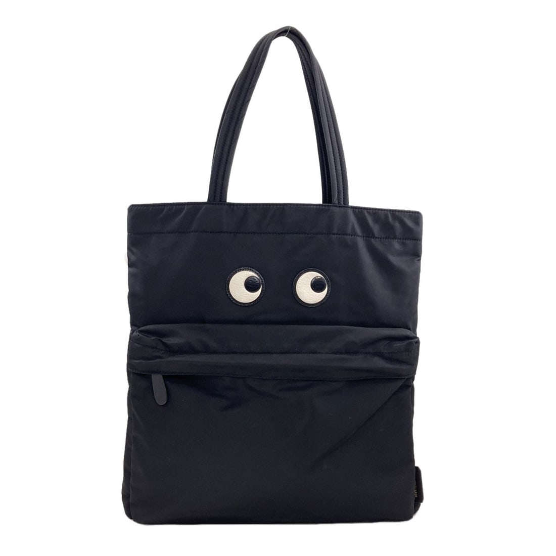 Hindmarch Eyes Nylon Tote An Anya: Hindmarch Eyes Nylon Tote An Anya Black nylon tote bag from Anya Hindmarch, featuring a sleek and modern design. The bag's exterior material is made of durable nylon, providing a long-lasting and vers