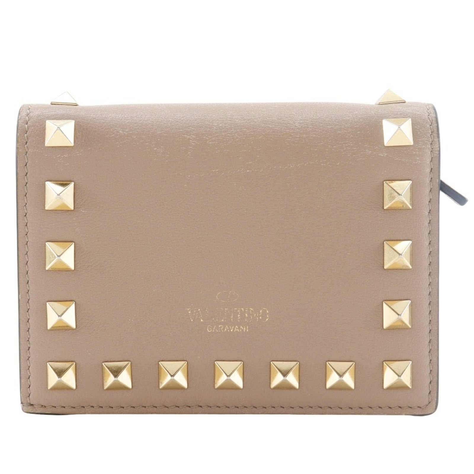 Valentino Wallet (Bi-Fold) Leather: Valentino Wallet (Bi-Fold) Leather Valentino's bi-fold leather wallet boasts a sleek design with a classic beige color, crafted from high-quality calfskin. The elegant dimensions and lightweight weigh