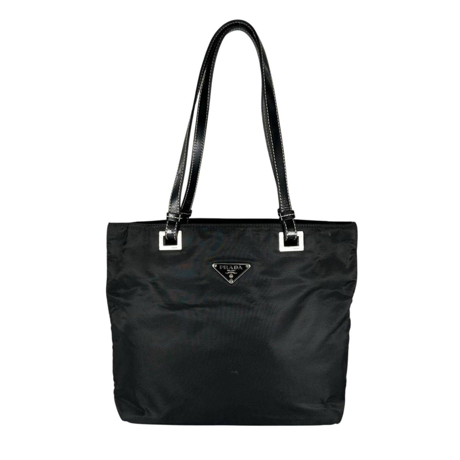 Nylon Tote Bag Prada: Nylon Tote Bag Prada Nylon tote bag from Prada, made in Italy with a sleek black design and silver hardware. The compact size measures 23cm x 23cm x 10cm, making it perfect for everyday use. This vers
