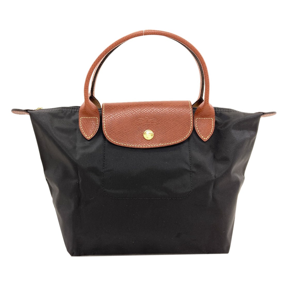 Longchamp Le Pliage Handbag Nylon: Longchamp Le Pliage Handbag Nylon Black Longchamp Le Pliage Handbag made from durable nylon, featuring a timeless design that combines style and functionality. The bag's signature foldable design