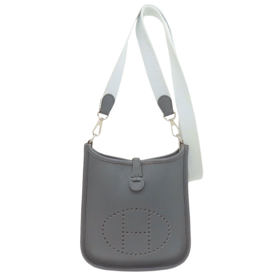 Hermes Evelynetpm Silverhardware Shoulder Bag Taurillon Clemence: Hermes Evelynetpm Silverhardware Shoulder Bag Taurillon Clemence Silver hardware adorns the elegant Taurillon Clemence exterior of this blue shoulder bag, evoking sophistication and refinement. The di