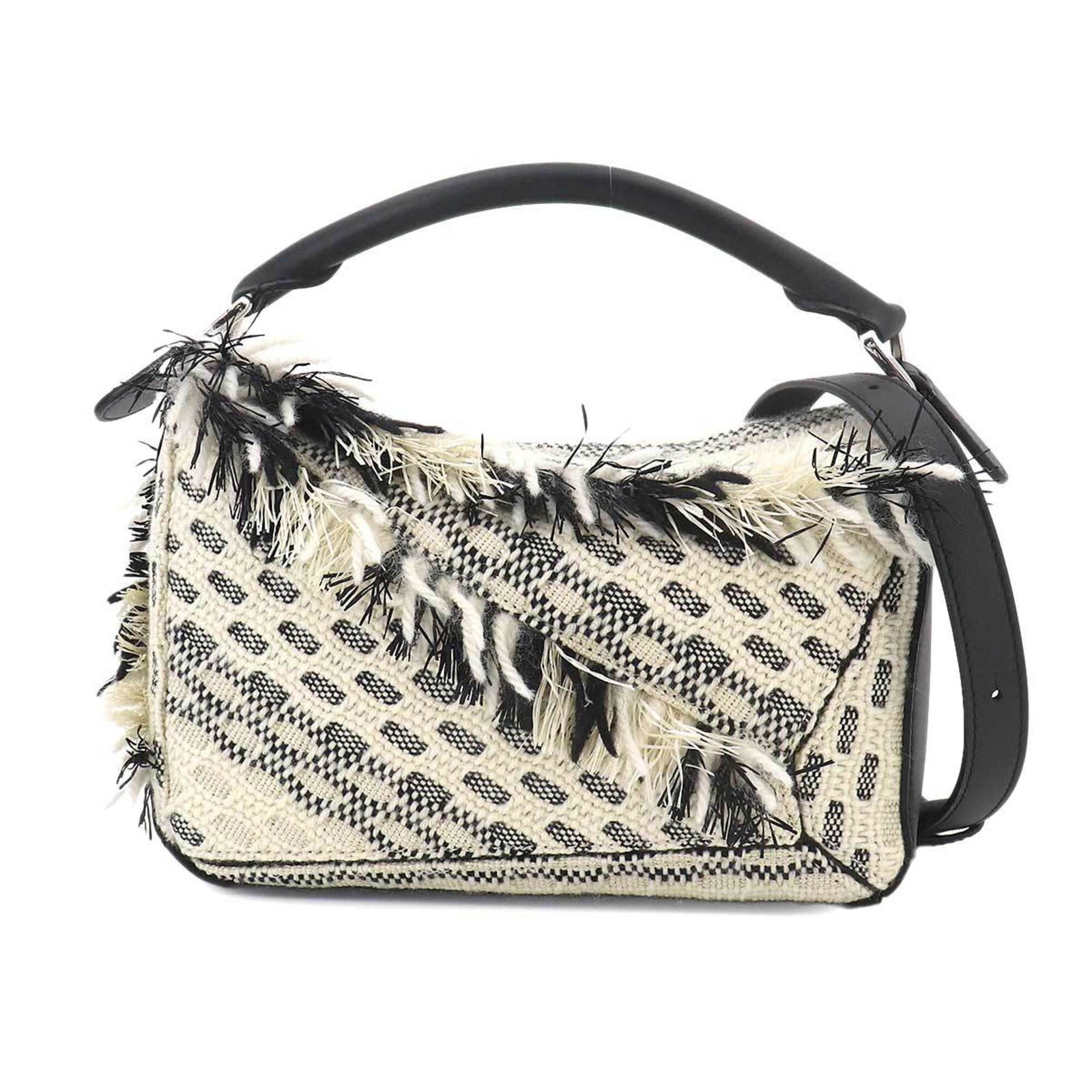 Cotton Leather Handbag by Loewe: Cotton Leather Handbag by Loewe Cotton Leather Handbag by Loewe. This handbag features a unique blend of cotton and leather materials, with a black and white color scheme. Measuring 18cm x 24cm x 10.5