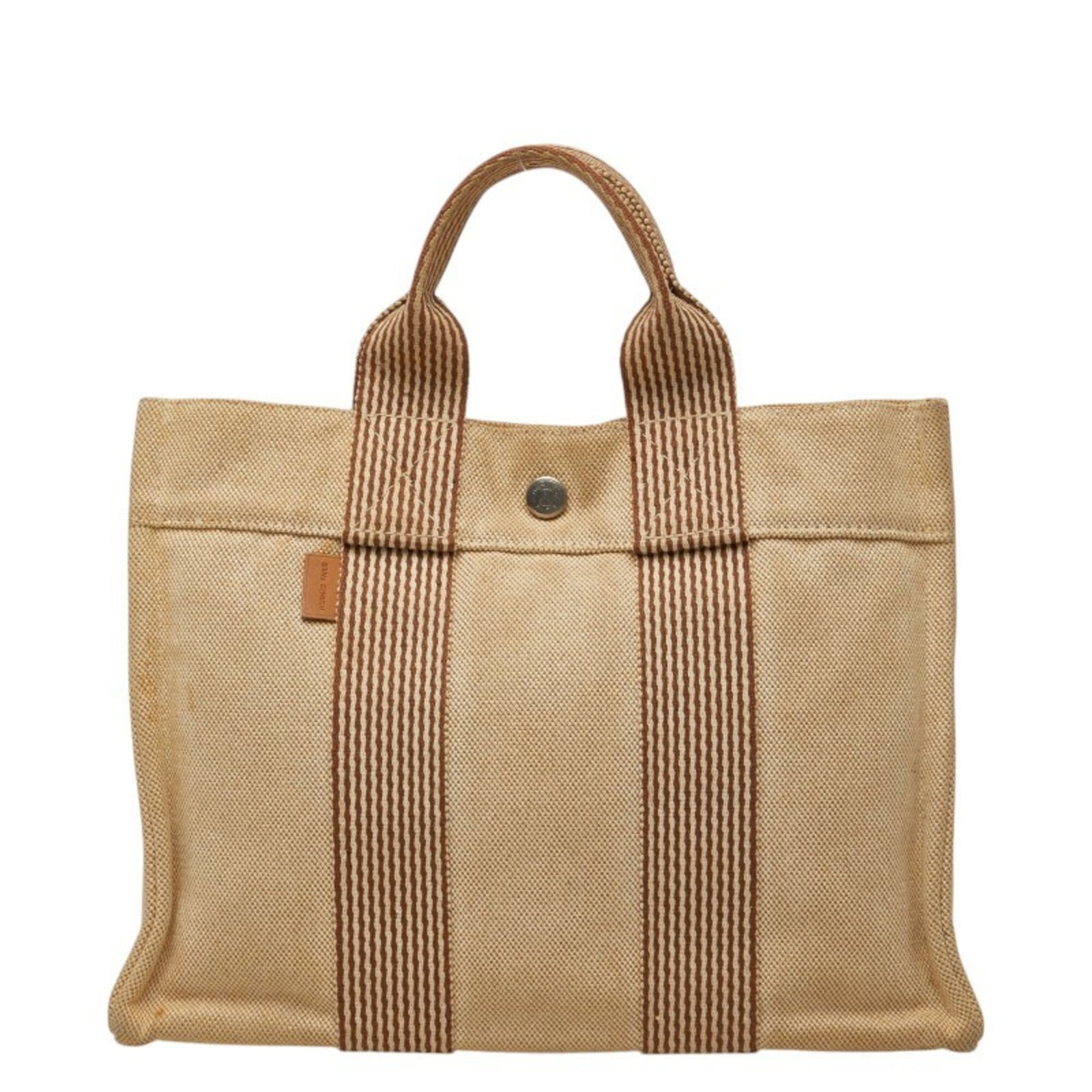 Hermes Tote Bag Canvas: Hermes Tote Bag Canvas Canvas tote bag from Hermes, featuring a classic design with a natural beige and brown color combination. Made from high-quality canvas material, this bag measures 22cm x 30cm x