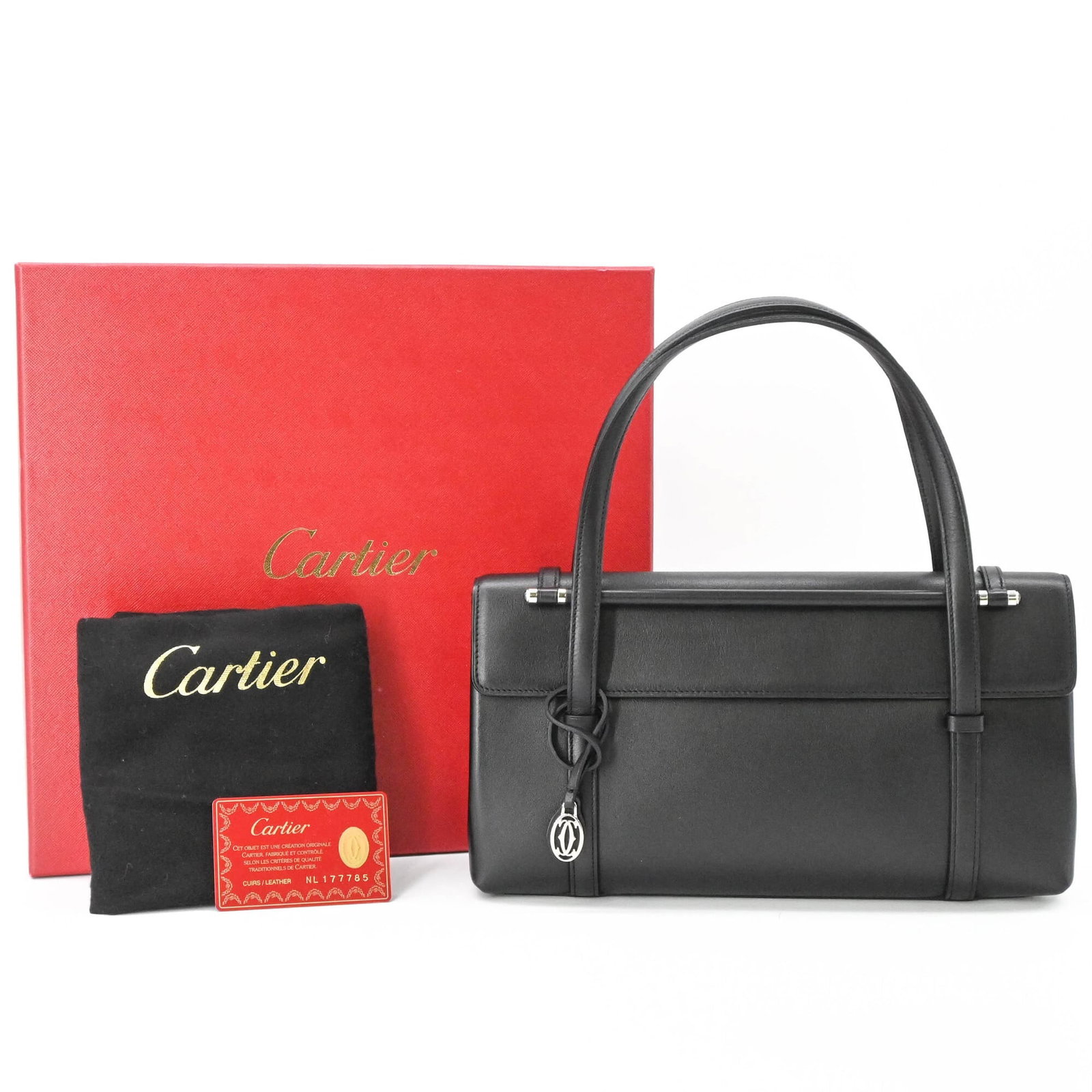Handbag Leather Cartier: Handbag Leather Cartier Cartier's sleek design is showcased in this black leather handbag, measuring 15cm x 30cm x 6cm. The bag's compact size and classic style make it a versatile accessory for every