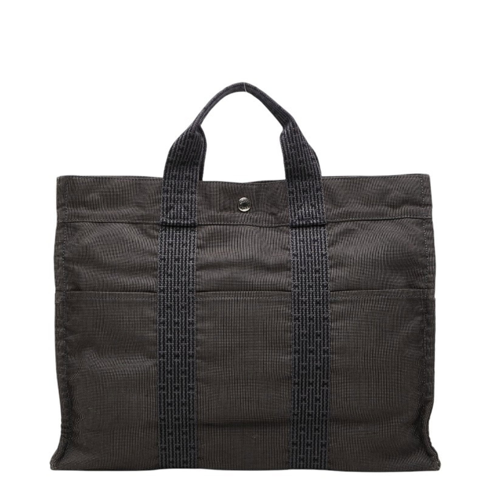 Handbag Hermes Tote Canvas: Handbag Hermes Tote Canvas Canvas Handbag with Zipper Closure, Ideal for Everyday Use. This versatile tote bag from the iconic Hermes Line features a sturdy canvas material and a practical zipper