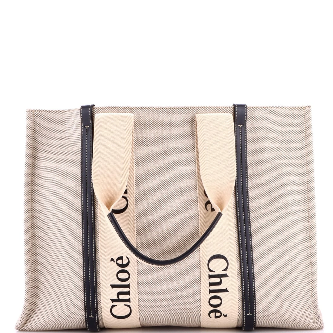 Canvas tote large leather with Chloe Woody: Canvas tote large leather with Chloe Woody Canvas tote with large leather strap, featuring the iconic Chloe Woody design in neutral colors. This large tote measures 17.5" wide and 12.5" tall, making i