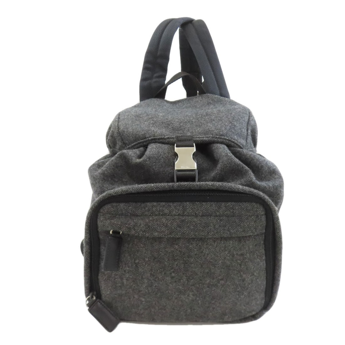 Wool backpack hardware daypack logo: Wool backpack hardware daypack logo The wool backpack hardware daypack logo features a gray exterior with a notable wool material. This PRADA-style daypack boasts a distinctive design, making it stand