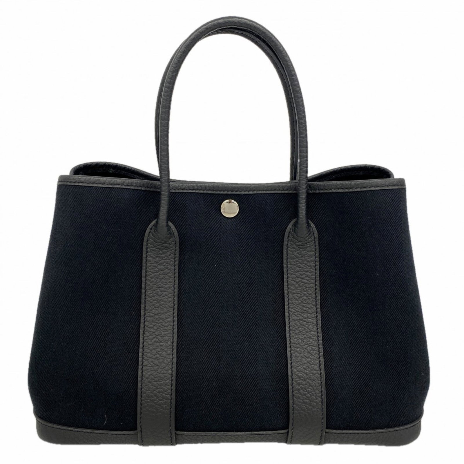 Hermes Tote Bag Canvas: Hermes Tote Bag Canvas Canvas tote bag from the renowned French fashion house Hermes, featuring a sleek black design with silver hardware. This classic style measures 21cm x 30.5cm x 14cm and boasts a